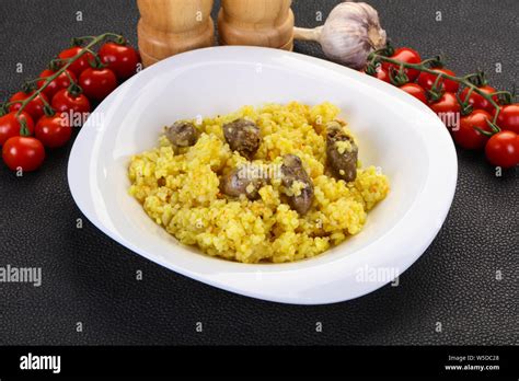 Rice with Chicken hearts and spices Stock Photo - Alamy