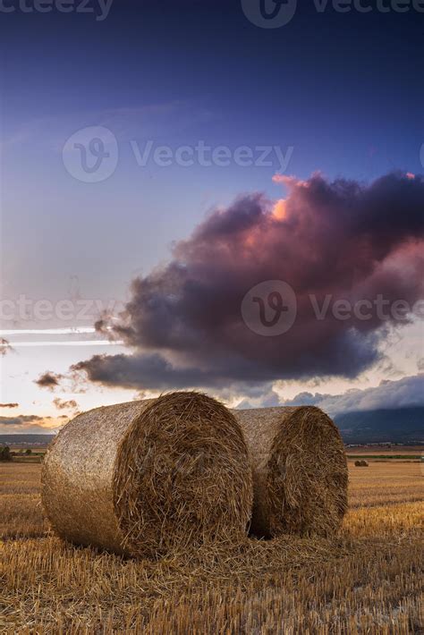 Round straw bales in the fields at sunset 1332286 Stock Photo at Vecteezy