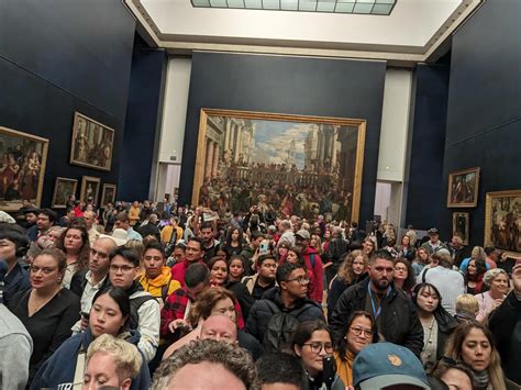 A huge crowd to see the mona lisa (there is a painting behind) - Images