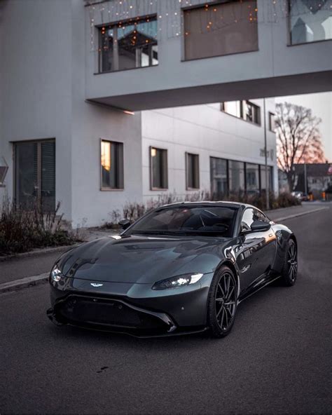 a black sports car parked in front of a building