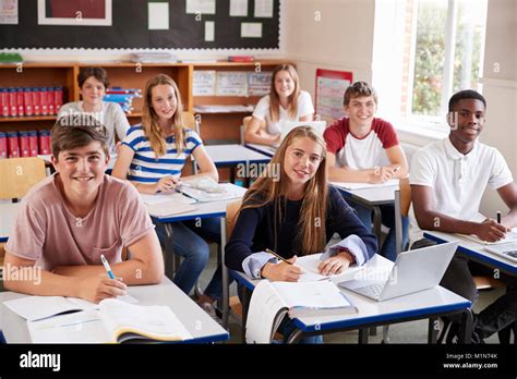 Portrait Of Students Sitting At Desks In Classroom Stock Photo - Alamy