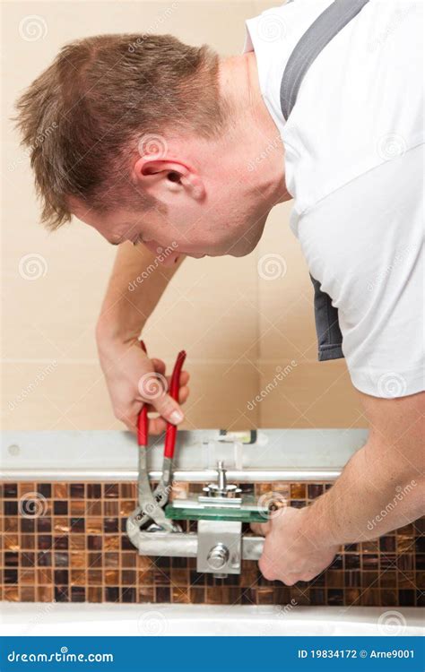 Plumber Installing a Mixer Tap in a Bathroom Stock Photo - Image of ...