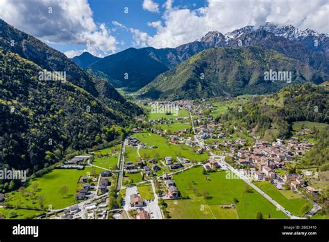 The Improbable aerial landscape of village Molveno, Italy, snow covered mountains Dolomites on ...