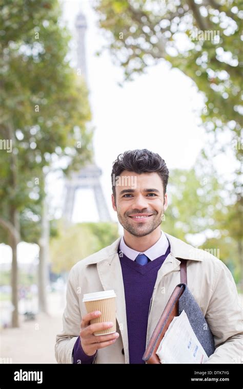 Businessman smiling in park near Eiffel Tower, Paris, France Stock Photo - Alamy