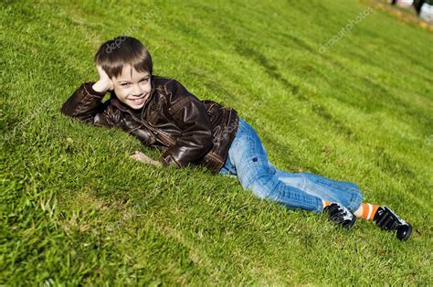 Little boy Lying Down on the grass — Stock Photo © vekozlov #4207087