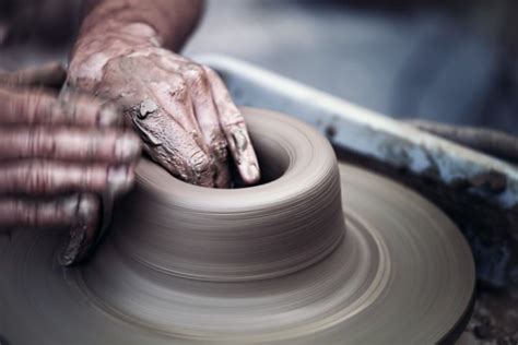 Hands working on pottery wheel — Stock Photo © GPimages #48381055