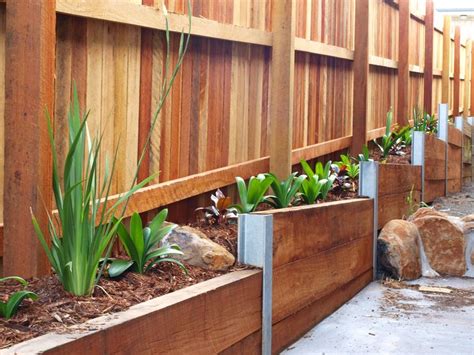 Timber retaining wall on boundary fence. This is going to look great once the plants a ...