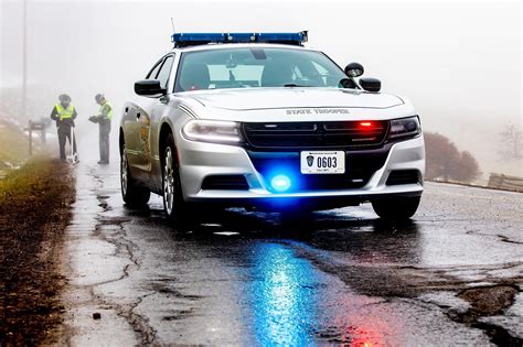 a police car driving down a wet road