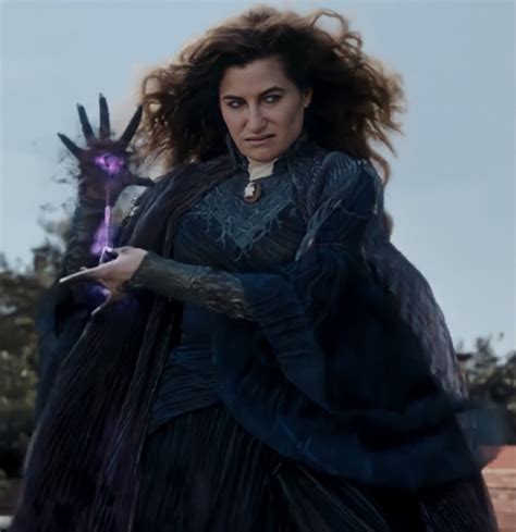 a woman dressed in black holding a purple object