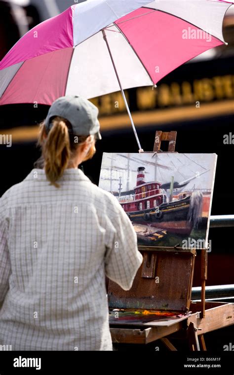 An artist painting a tugboat Stock Photo - Alamy