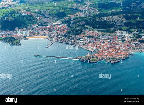 aerial of village Castro Urdiales with 2 piers and sandy beach in ...