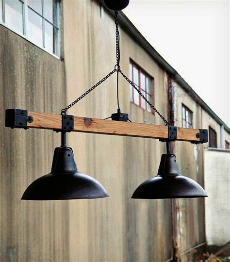 Huge industrial-style chandelier made with a recycled wood beam and black lamp shades. The ...