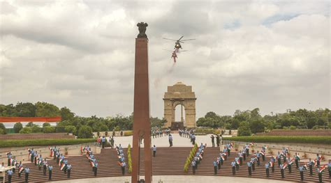 Indian Air Force helicopters shower flower petals during the flag-in ceremony of IAF’s Mountain ...