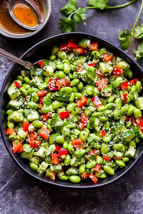 This simple Asian Edamame Salad packs a punch of flavor! Shelled edamame, cucumbers, red bell ...