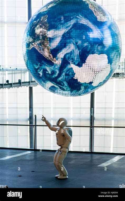 Honda's ASIMO robot points towards a giant earth at The National Museum ...