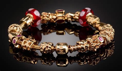 Lot Detail - 14K GOLD PANDORA BRACELET WITH 21 CHARMS & CLIPS.