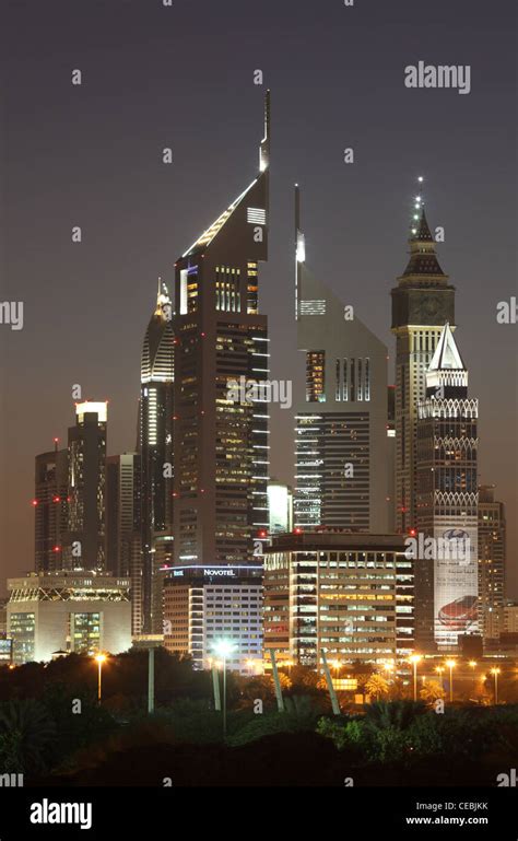 Skyscrapers in Dubai illuminated at night Stock Photo - Alamy