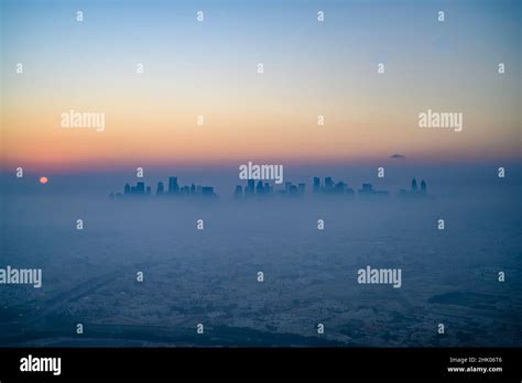 Doha skyline at sunrise with morning fog Stock Photo - Alamy