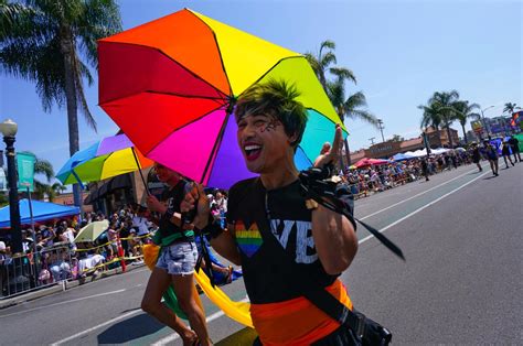 Crowd watches joyous San Diego Pride parade participants march, dance ...