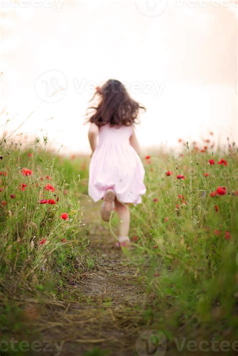 Little girl running away in a field of poppies 831685 Stock Photo at Vecteezy