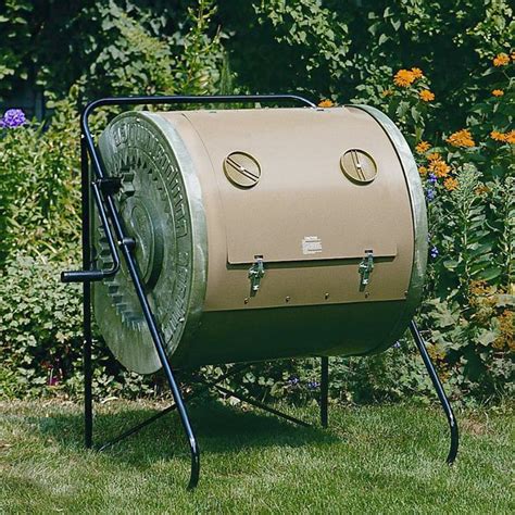 a large green barrel sitting on top of a lush green grass covered field ...