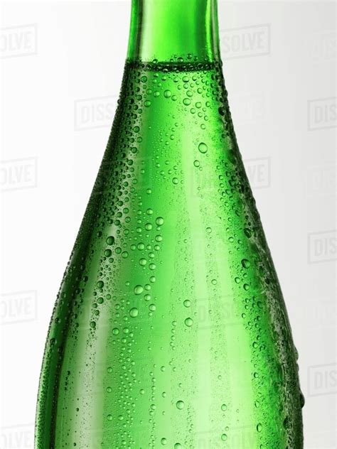 Green glass bottle with condensation (detail) - Stock Photo - Dissolve