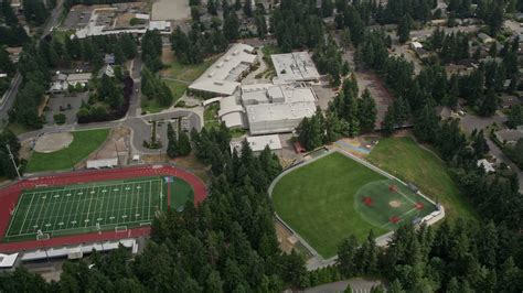 5K stock footage aerial video flying by sports fields and Interlake High School, Bellevue ...