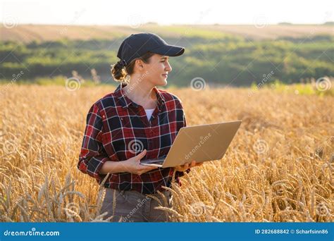 Woman Farmer Working with Laptop on Wheat Field. Stock Photo - Image of ...