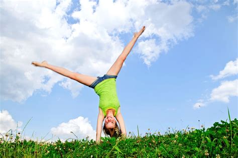 Girl Doing Cartwheel In A Summer Meadow – Flair