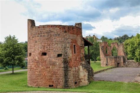 an old brick tower with windows in the middle of a park