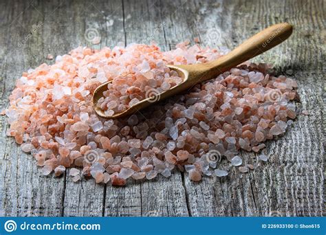 A Pile of Large Crystals of Pink Himalayan Salt on an Aged Rough Board ...