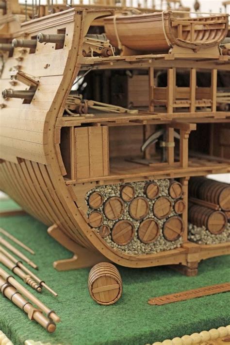 a wooden model of a ship with lots of woodworking tools on it's side