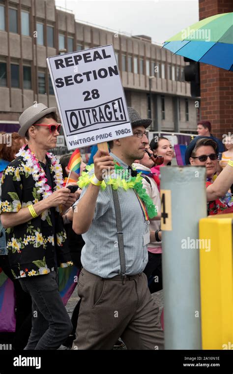 A man smoking a pipe carrying a sign saying Repeal Section 28 Outrage ...