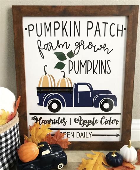 a pumpkin patch sign is next to some fall decorations