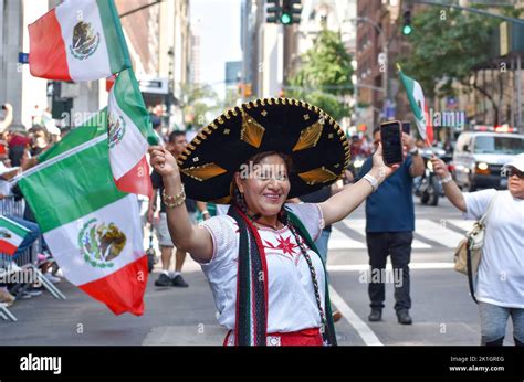 An elder participant is seen waving a Mexican flag proudly at the ...