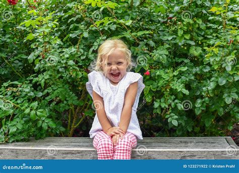 Happy Little Girl Sitting in the Garden on a Summer Day Stock Photo - Image of blonde, giggling ...