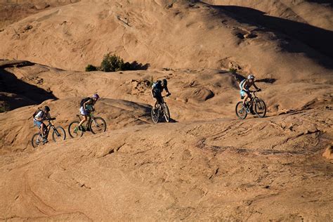 Group Mountain Biking, Moab, Utah Photograph by Whit Richardson - Fine Art America