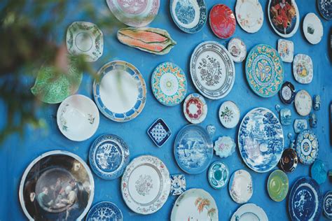 Decorative ceramic plates on blue wall · Free Stock Photo