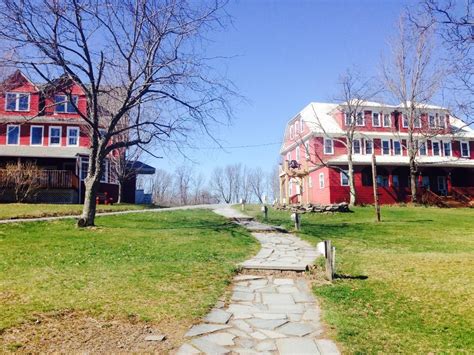 a stone path in front of two red houses