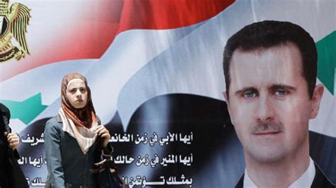 Election posters of Syria's President Bashar al-Assad hang above a road ...