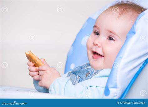 Happy Toddler Eating Cookie Stock Photo - Image of chair, eyes: 17139652