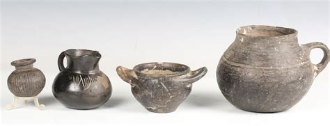 A group of ancient black ware pottery, including an Etruscan burnished impasto ware twin-handled bow