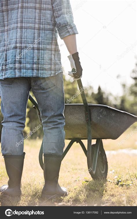 Man pushing wheelbarrow — Stock Photo © londondeposit #138117092