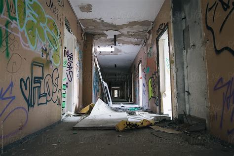 Abandoned Hallway Of Apartment Building With Graffiti by Willy Able