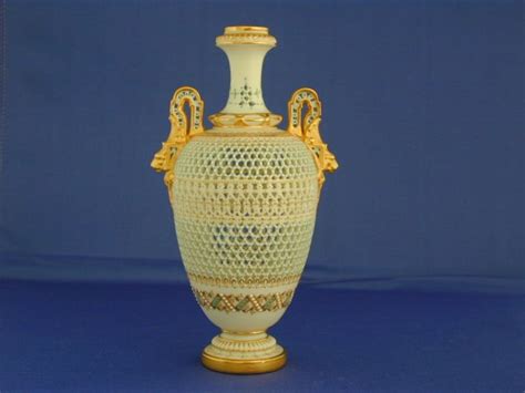 an ornate vase is sitting on a blue surface