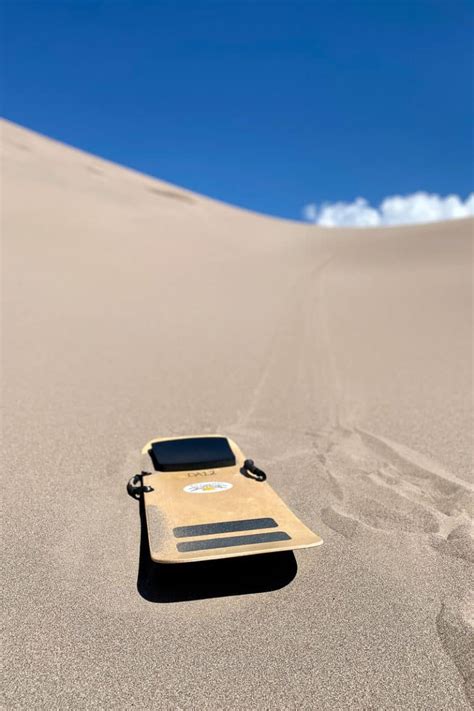 Sandboarding in Colorado (Great Sand Dunes) - Champagne Tastes®