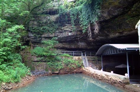 there is a small pool in the middle of this cave with stairs leading up ...