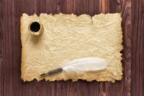 Premium Photo | Old paper and inkstand with quill pen on a wood background