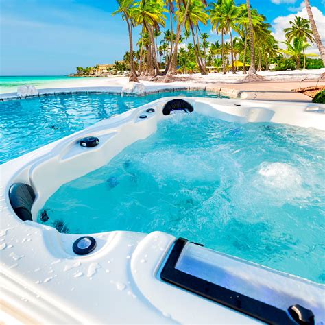 an outdoor jacuzzi is shown with palm trees in the background and blue ...