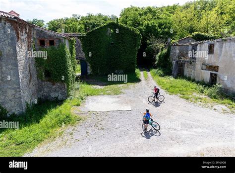 Mother and son cycling at the ruins of Loze castle, Vipava Valley ...